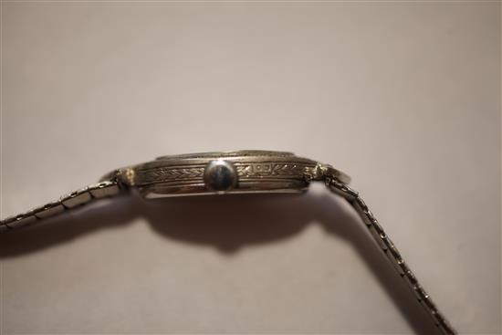 A ladys late 1920s 18ct white gold and diamond set cocktail watch,